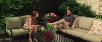 Movie still from “Irrational Man” (2015), directed by Woody Allen – A man and a woman sitting on a couch talking to each other; Wide shot, Over the shoulder angle