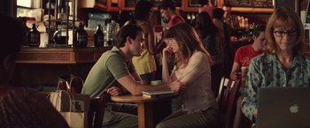 Movie still from “Irrational Man” (2015), directed by Woody Allen – A man and a woman sitting at a table in front of a laptop; Medium shot, Over the shoulder angle