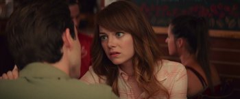 Movie still from “Irrational Man” (2015), directed by Woody Allen – A person sitting at a table; Close Up shot, Over the shoulder angle