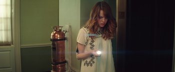 Movie still from “Irrational Man” (2015), directed by Woody Allen – A woman is holding a flashlight in her hand; Medium shot, High angle