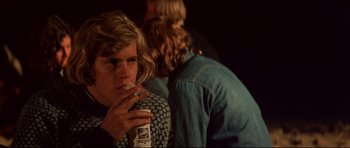 Movie still from “Jaws” (1975), directed by Steven Spielberg – A man smoking a cigarette while another man looks on; Close Up shot, Over the shoulder angle