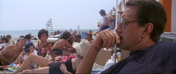 Movie still from “Jaws” (1975), directed by Steven Spielberg – A group of people sitting on the beach; Close Up shot, Low angle