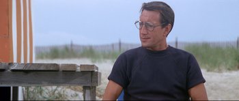 Movie still from “Jaws” (1975), directed by Steven Spielberg – A person sitting on a bench; Close Up shot, Low angle