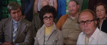 Movie still from “Jaws” (1975), directed by Steven Spielberg – An older woman wearing glasses in front of an older man; Medium shot, High angle