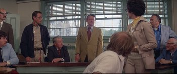 Movie still from “Jaws” (1975), directed by Steven Spielberg – A man standing in front of two other men; Medium shot, Low angle