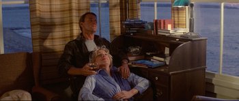 Movie still from “Jaws” (1975), directed by Steven Spielberg – A man and a woman sitting next to each other in front of a desk; Medium shot, High angle