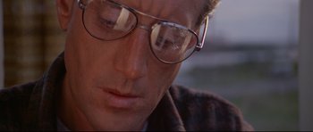 Movie still from “Jaws” (1975), directed by Steven Spielberg – A person wearing glasses; Close Up shot, Low angle