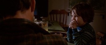 Movie still from “Jaws” (1975), directed by Steven Spielberg – A man sitting at a table with a small child; Medium shot, Over the shoulder angle