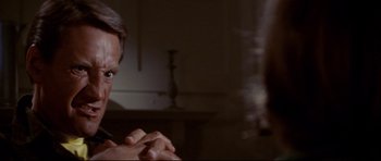 Movie still from “Jaws” (1975), directed by Steven Spielberg – A man with glasses is holding his hands in a room; Close Up shot, Over the shoulder angle