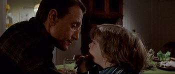 Movie still from “Jaws” (1975), directed by Steven Spielberg – A man and a boy sitting at a dinner table; Close Up shot, Over the shoulder angle