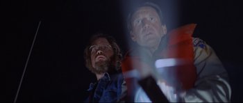 Movie still from “Jaws” (1975), directed by Steven Spielberg – A man with a beard and glasses and another man with a beard and glasses; Medium shot, Low angle