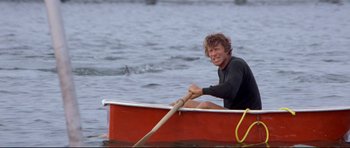 Movie still from “Jaws” (1975), directed by Steven Spielberg – A man rowing a boat on a body of water; Medium shot, Low angle