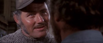 Movie still from “Jaws” (1975), directed by Steven Spielberg – A person wearing a hat; Close Up shot, Over the shoulder angle