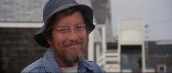Movie still from “Jaws” (1975), directed by Steven Spielberg – A person wearing glasses and a hat; Close Up shot, Low angle