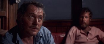 Movie still from “Jaws” (1975), directed by Steven Spielberg – A person sitting on a couch looking at the camera; Close Up shot, Over the shoulder angle