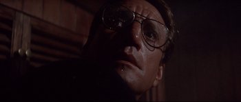 Movie still from “Jaws” (1975), directed by Steven Spielberg – A person wearing glasses with water on their face; Close Up shot, Low angle
