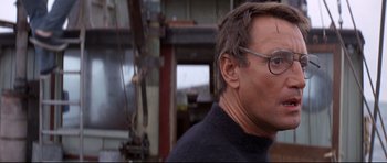 Movie still from “Jaws” (1975), directed by Steven Spielberg – A person wearing glasses; Close Up shot, Low angle