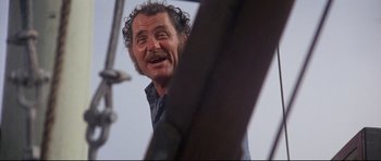 Movie still from “Jaws” (1975), directed by Steven Spielberg – An older man with curly hair and a mustache; Medium shot, Low angle
