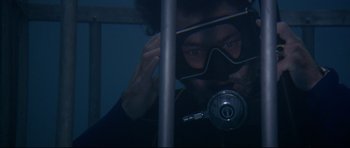 Movie still from “Jaws” (1975), directed by Steven Spielberg – A man in a scuba mask looking at the camera; Close Up shot, Overhead angle