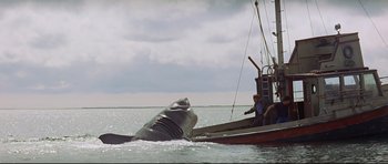 Movie still from “Jaws” (1975), directed by Steven Spielberg – A boat with two people on it in the water; Extreme Wide shot, Low angle