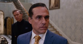 Movie still from “Joy” (2015), directed by David O. Russell – A person wearing a suit and a tie; Close Up shot, Over the shoulder angle