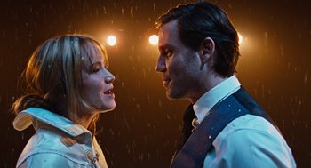 Movie still from “Joy” (2015), directed by David O. Russell – A man and a woman standing next to each other in the rain; Close Up shot, Low angle