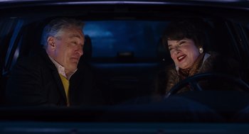 Movie still from “Joy” (2015), directed by David O. Russell – A man and a woman sitting in the back seat of a car; Close Up shot, Over the shoulder angle