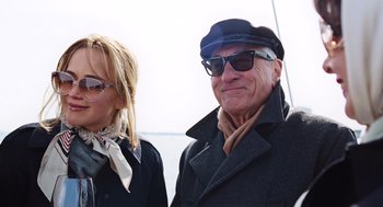 Movie still from “Joy” (2015), directed by David O. Russell – An older man and a younger woman wearing sunglasses and hats; Medium shot, Low angle