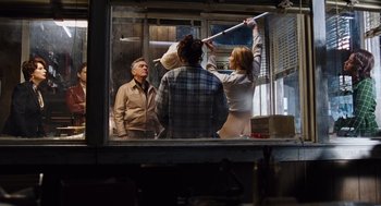 Movie still from “Joy” (2015), directed by David O. Russell – A group of people standing in front of an open window; Medium shot, Low angle