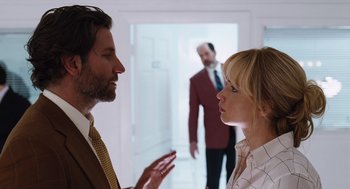 Movie still from “Joy” (2015), directed by David O. Russell – A man and a woman talking to each other; Medium shot, Over the shoulder angle