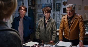 Movie still from “Joy” (2015), directed by David O. Russell – A group of people standing around a table; Medium shot, High angle