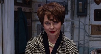 Movie still from “Joy” (2015), directed by David O. Russell – A person with short hair wearing a jacket; Close Up shot, Over the shoulder angle