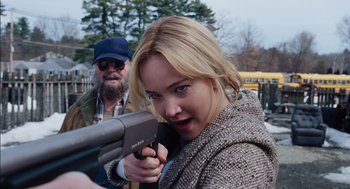 Movie still from “Joy” (2015), directed by David O. Russell – A woman holding a gun while standing next to a man; Close Up shot, Over the shoulder angle