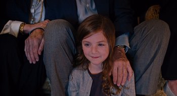 Movie still from “Joy” (2015), directed by David O. Russell – A little girl sitting next to an older man; Close Up shot, High angle