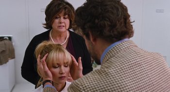 Movie still from “Joy” (2015), directed by David O. Russell – A man and a woman talking to another woman; Close Up shot, Over the shoulder angle