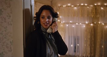 Movie still from “Joy” (2015), directed by David O. Russell – A woman holding a phone up to her ear; Close Up shot, Low angle