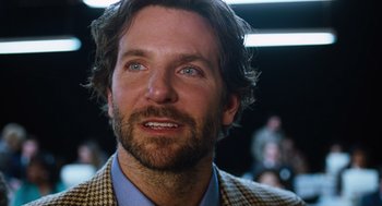 Movie still from “Joy” (2015), directed by David O. Russell – A man that is looking at the camera; Close Up shot, Over the shoulder angle