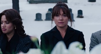 Movie still from “Joy” (2015), directed by David O. Russell – A woman in a black jacket standing in a cemetery; Close Up shot, Over the shoulder angle