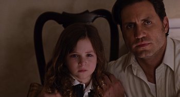 Movie still from “Joy” (2015), directed by David O. Russell – A man and a little girl in a dress shirt and tie; Close Up shot, Over the shoulder angle