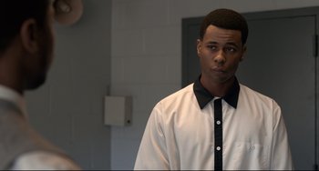 Movie still from “Just Mercy” (2019), directed by Destin Daniel Cretton – A man in a white shirt and a black tie; Close Up shot, Over the shoulder angle
