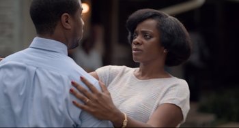 Movie still from “Just Mercy” (2019), directed by Destin Daniel Cretton – A man and a woman standing next to each other; Medium shot, Over the shoulder angle