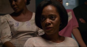 Movie still from “Just Mercy” (2019), directed by Destin Daniel Cretton – A person with short black hair; Close Up shot, Over the shoulder angle