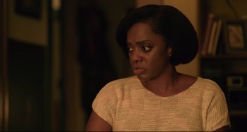 Movie still from “Just Mercy” (2019), directed by Destin Daniel Cretton – A black woman with short black hair is looking at the camera; Close Up shot, Over the shoulder angle