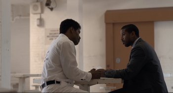 Movie still from “Just Mercy” (2019), directed by Destin Daniel Cretton – Two men sitting at a table talking to each other; Medium shot, Over the shoulder angle