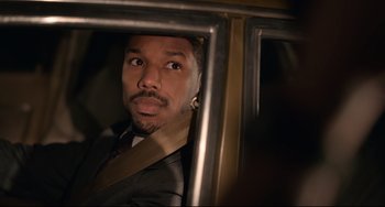 Movie still from “Just Mercy” (2019), directed by Destin Daniel Cretton – A man in a suit looking out of a car window; Close Up shot, Over the shoulder angle
