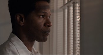 Movie still from “Just Mercy” (2019), directed by Destin Daniel Cretton – A person looking out of a window; Close Up shot, Low angle