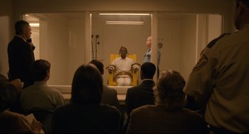 Movie still from “Just Mercy” (2019), directed by Destin Daniel Cretton – A group of people sitting in front of a yellow chair; Wide shot, High angle