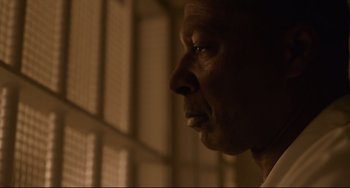 Movie still from “Just Mercy” (2019), directed by Destin Daniel Cretton – A person's face in a room; Close Up shot, Low angle
