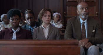 Movie still from “Just Mercy” (2019), directed by Destin Daniel Cretton – A group of people sitting in a court room; Medium shot, Over the shoulder angle