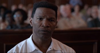 Movie still from “Just Mercy” (2019), directed by Destin Daniel Cretton – A person in a court room; Close Up shot, High angle